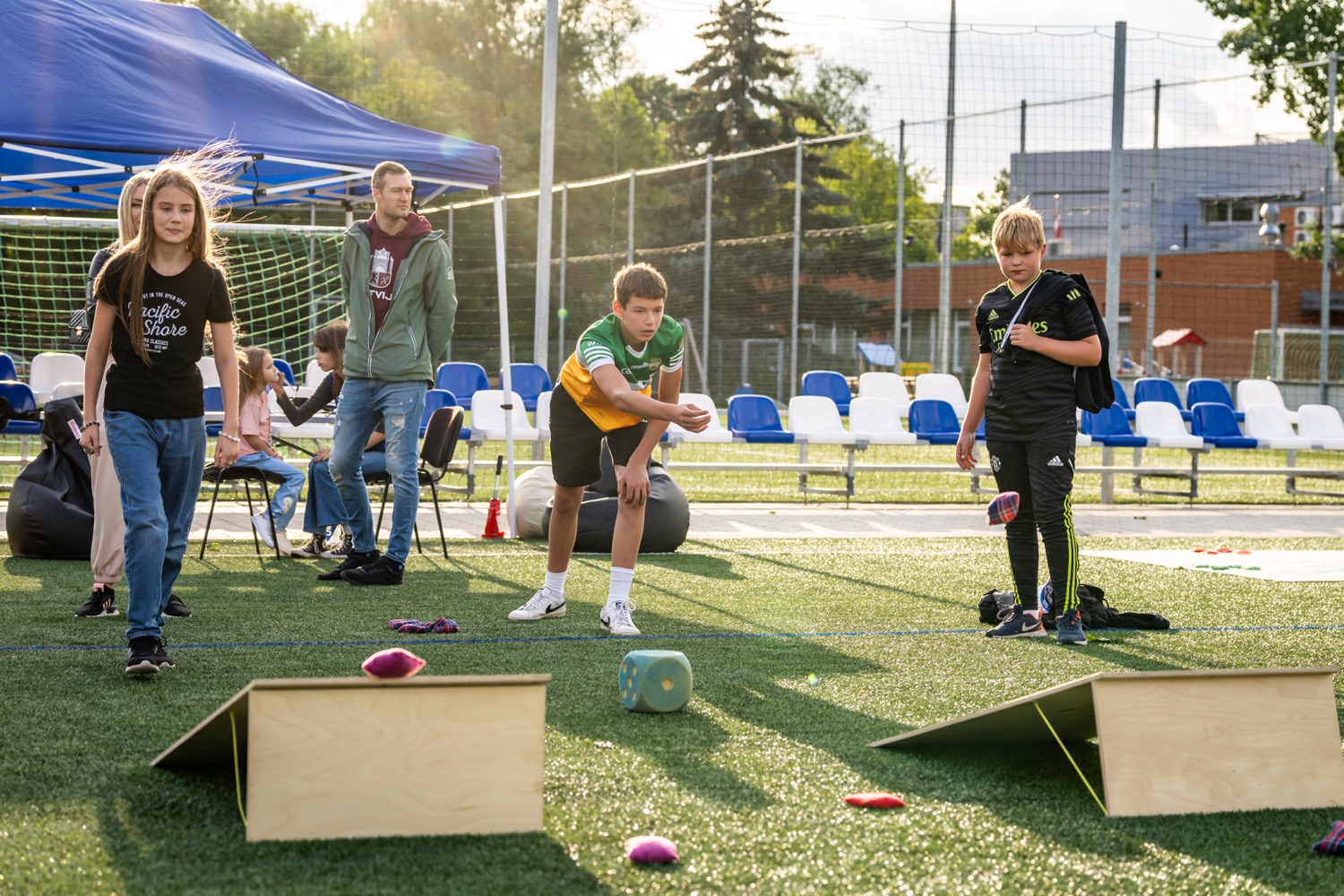 Teens playing a dice-toss ramp game