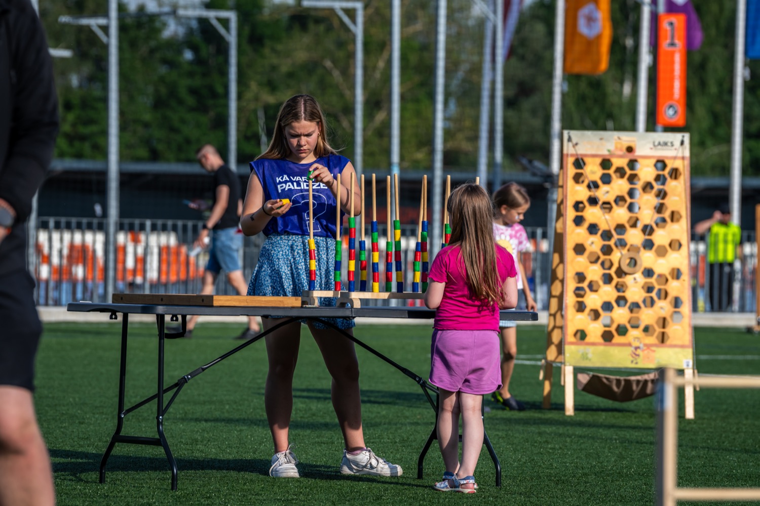 Girls playing the ring-toss tower game