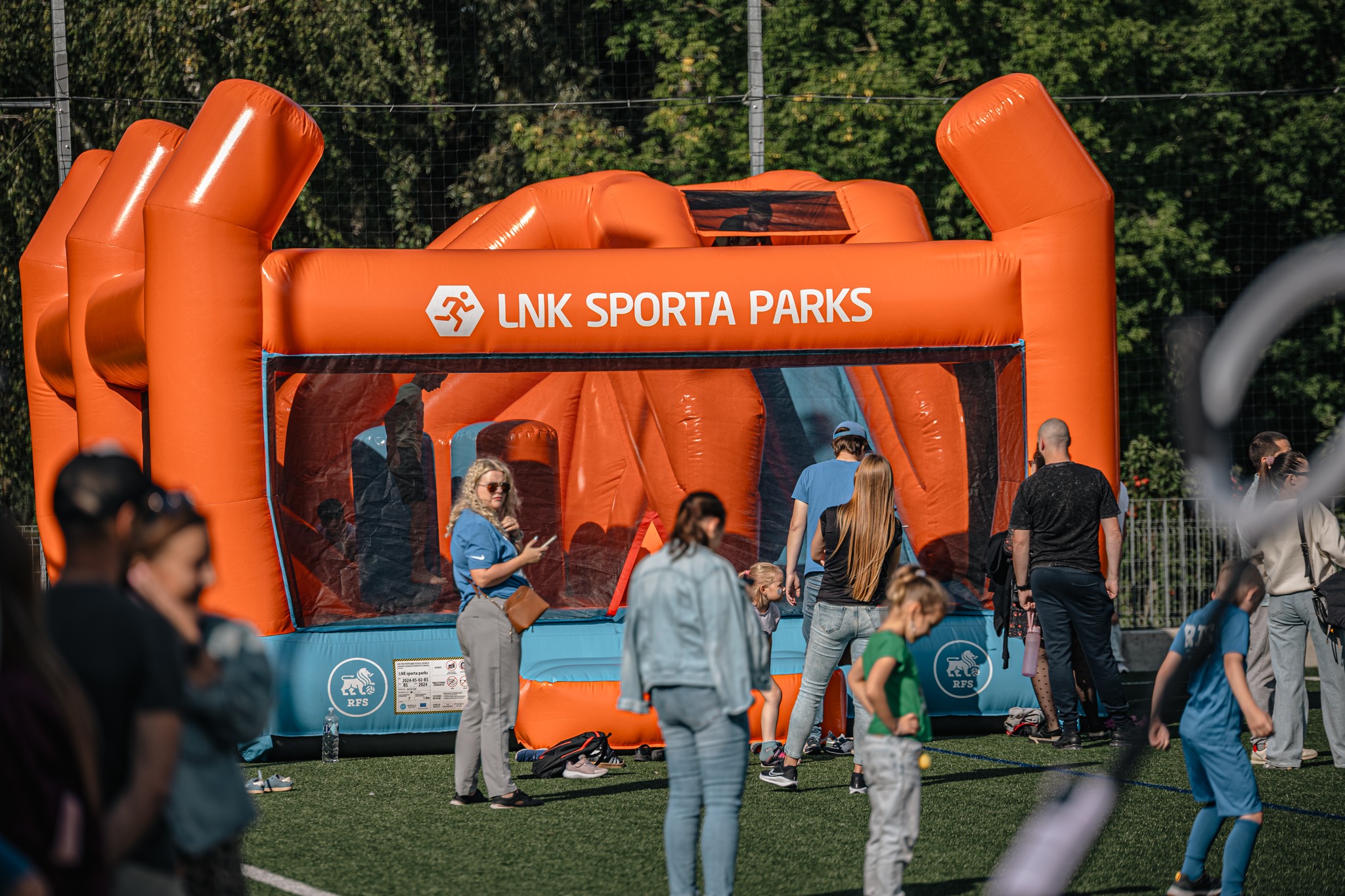 May be an image of 9 people, trampoline, grass and text