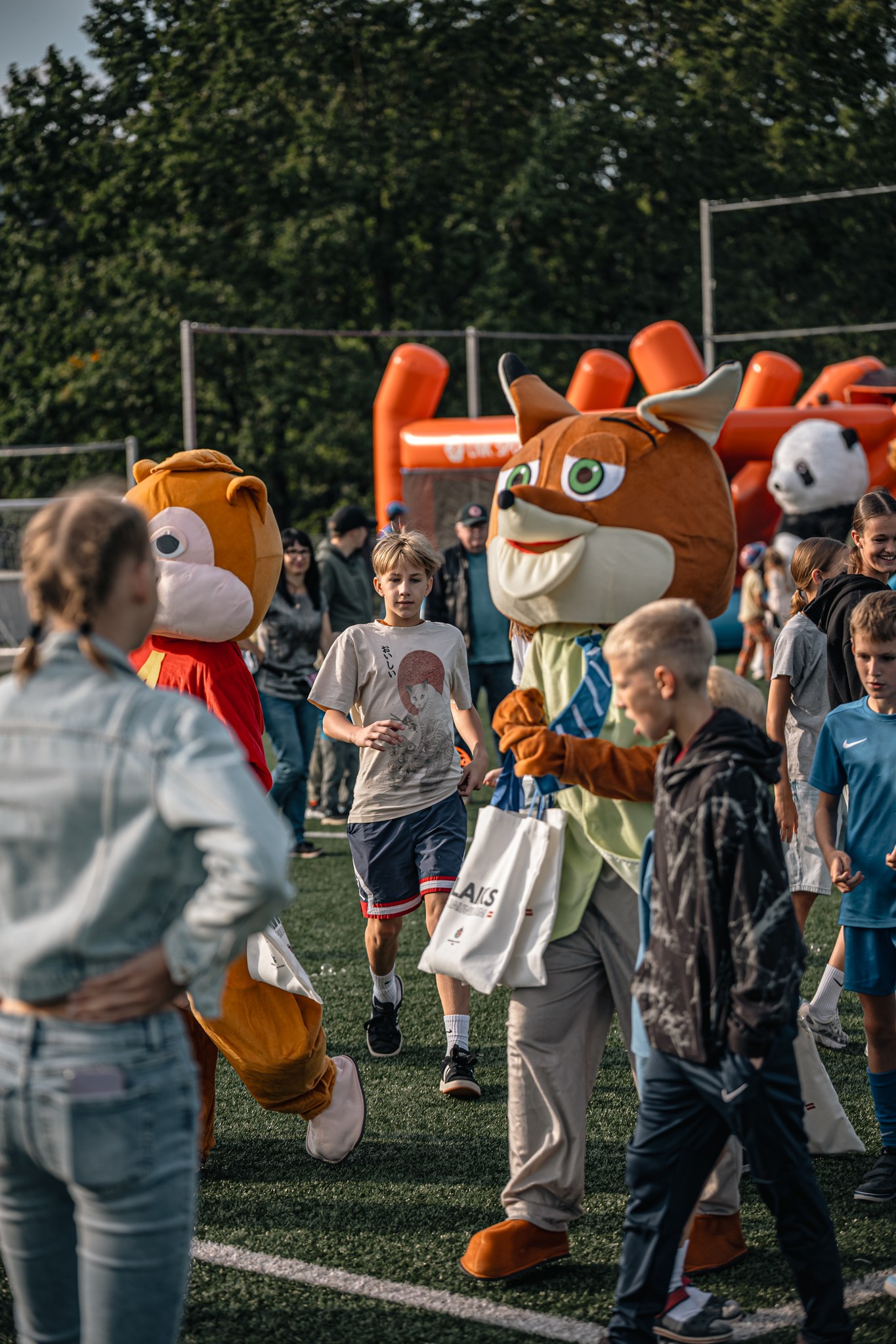 May be an image of 4 people, people playing soccer and crowd