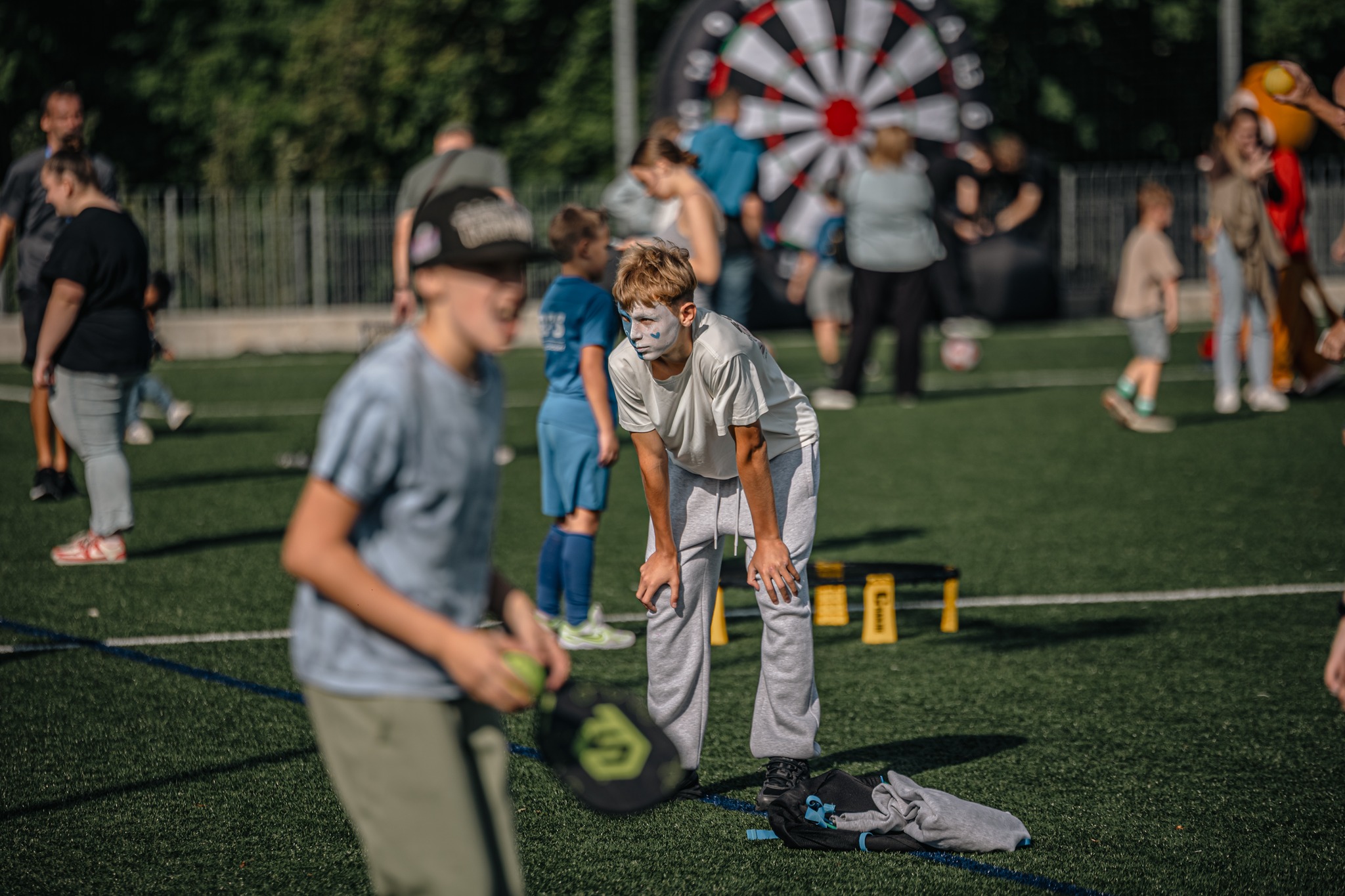 May be an image of 12 people, people playing football, people golfing, frisbee and dartboard