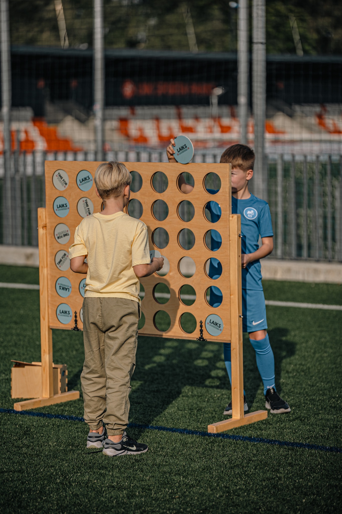 May be an image of 2 people, people playing football, people playing soccer and text