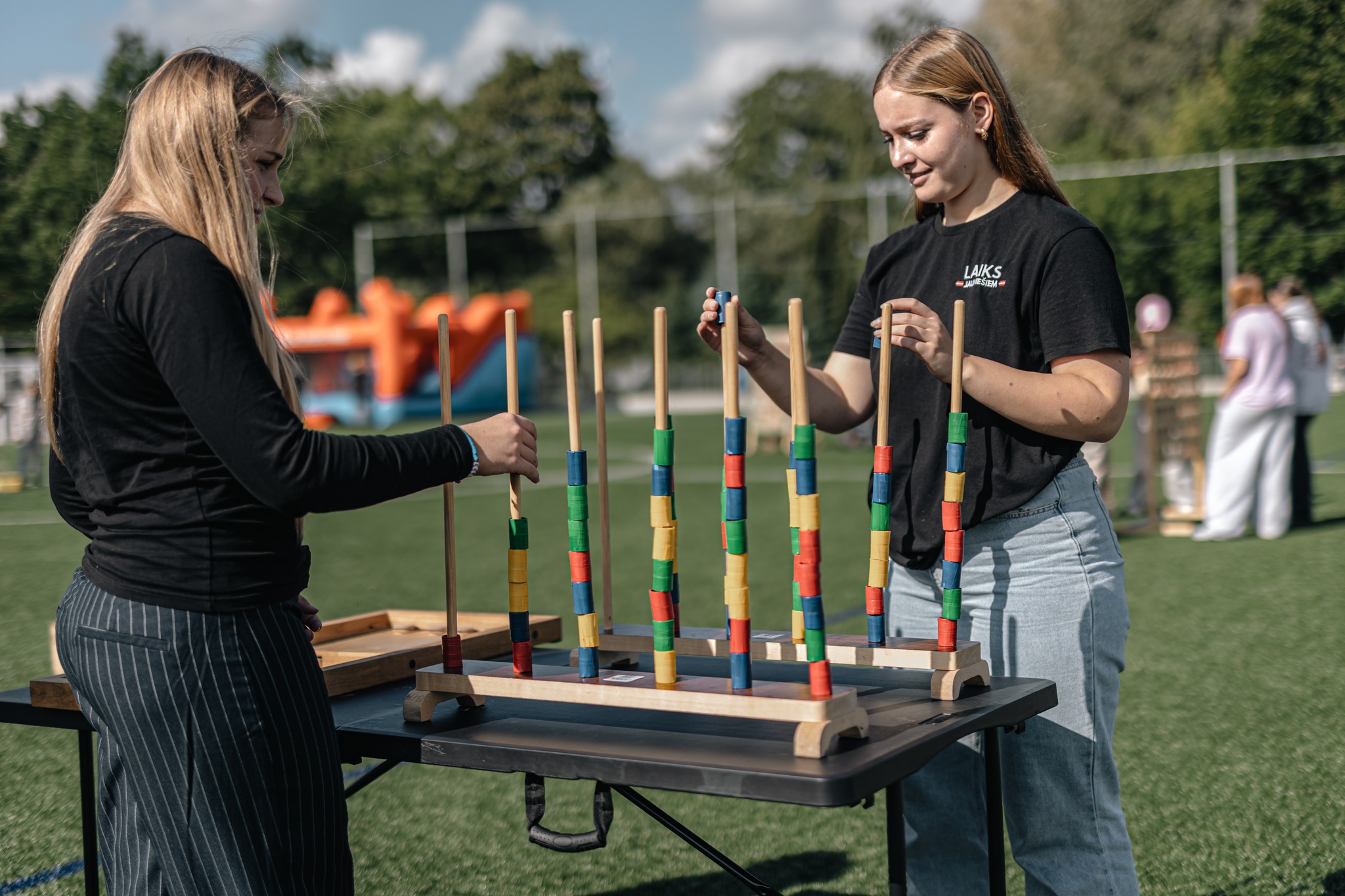 May be an image of 3 people, track and field and text