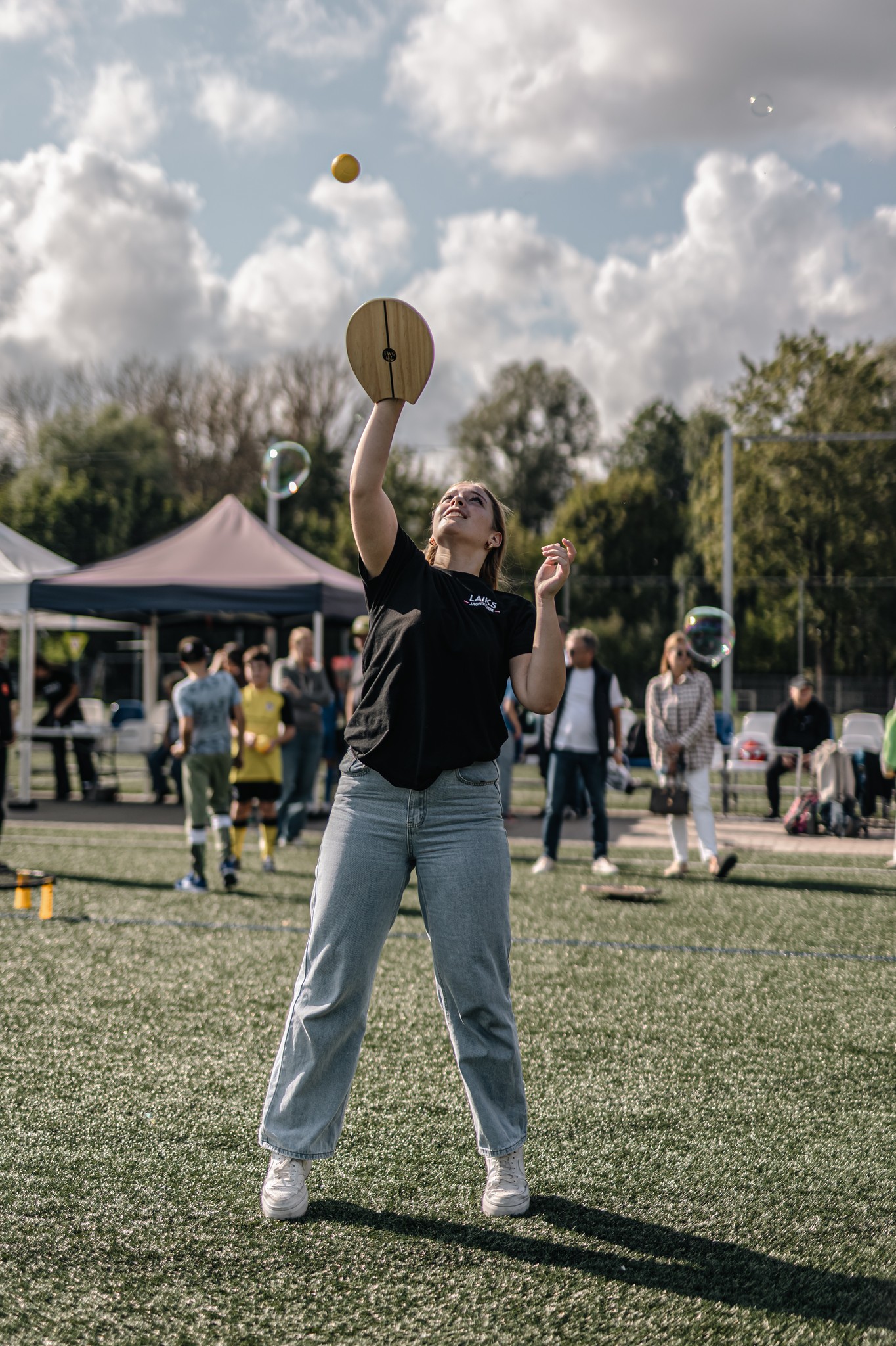 May be an image of 10 people, people playing football, track and field, frisbee and text