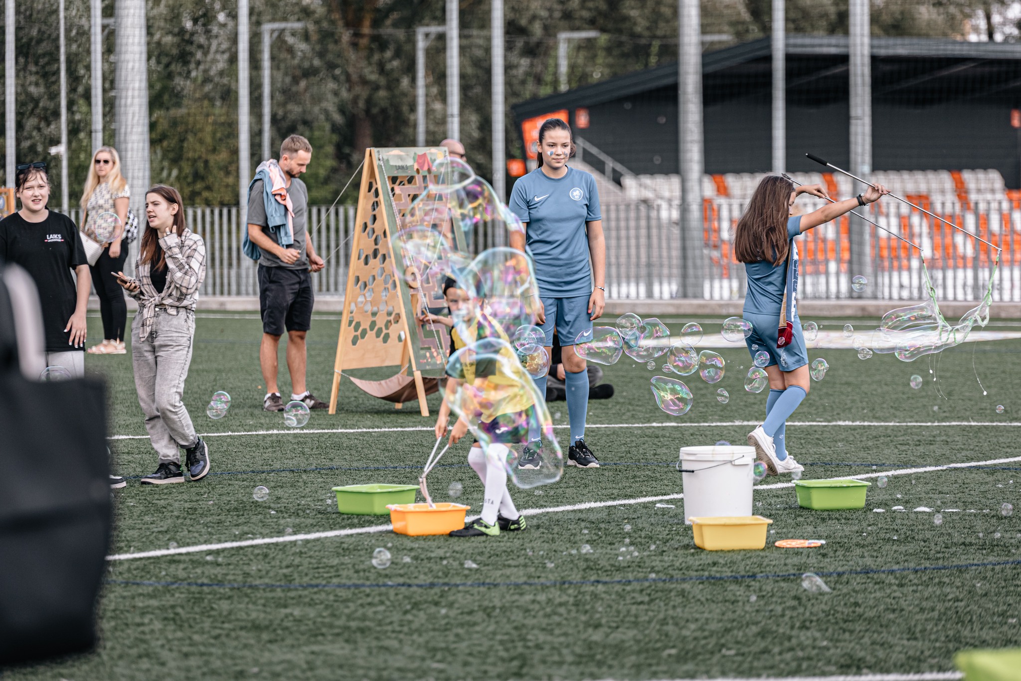 May be an image of 7 people, people playing football, people playing soccer, frisbee, grass and text