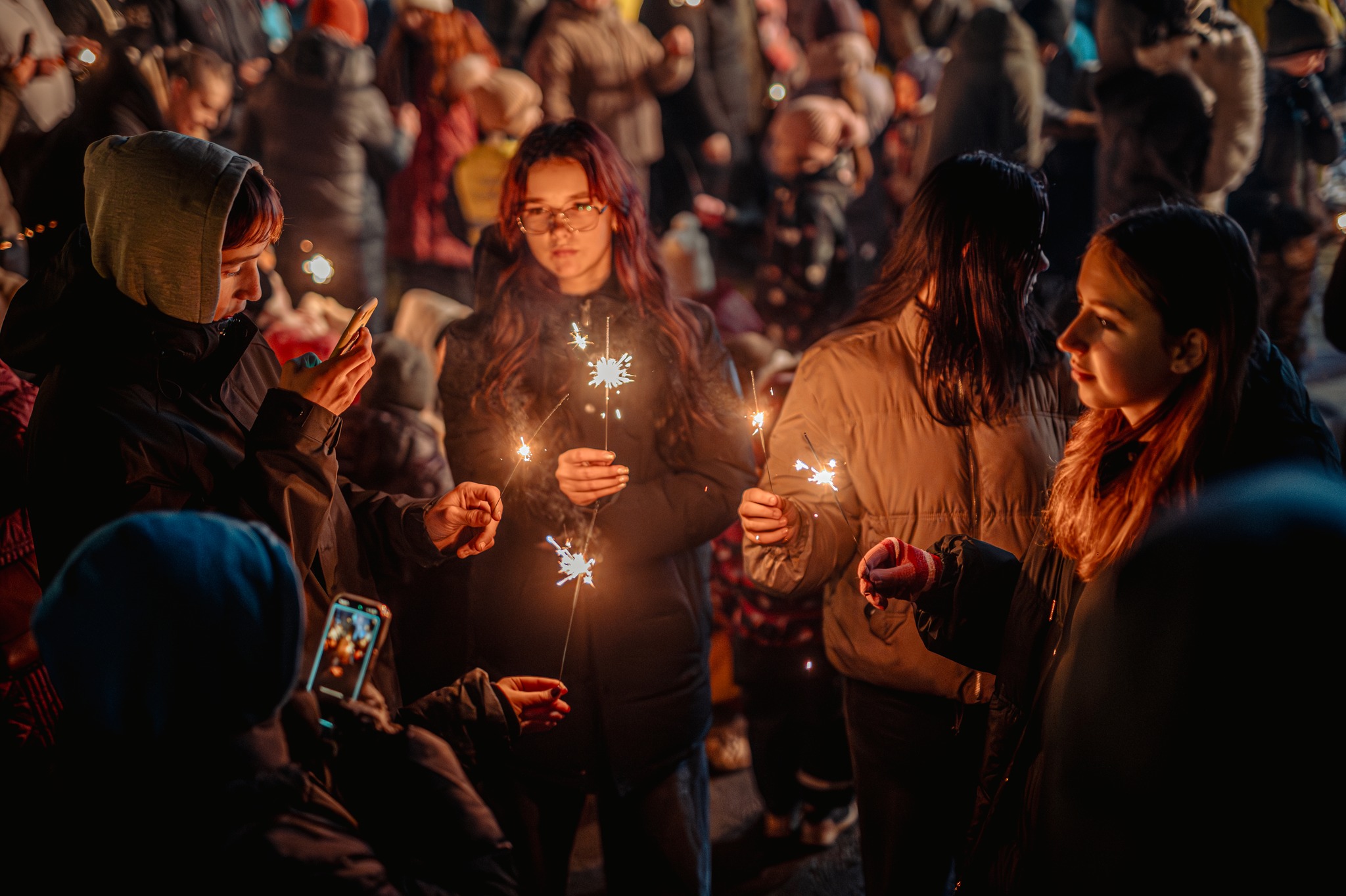 May be an image of one or more people, fire and crowd