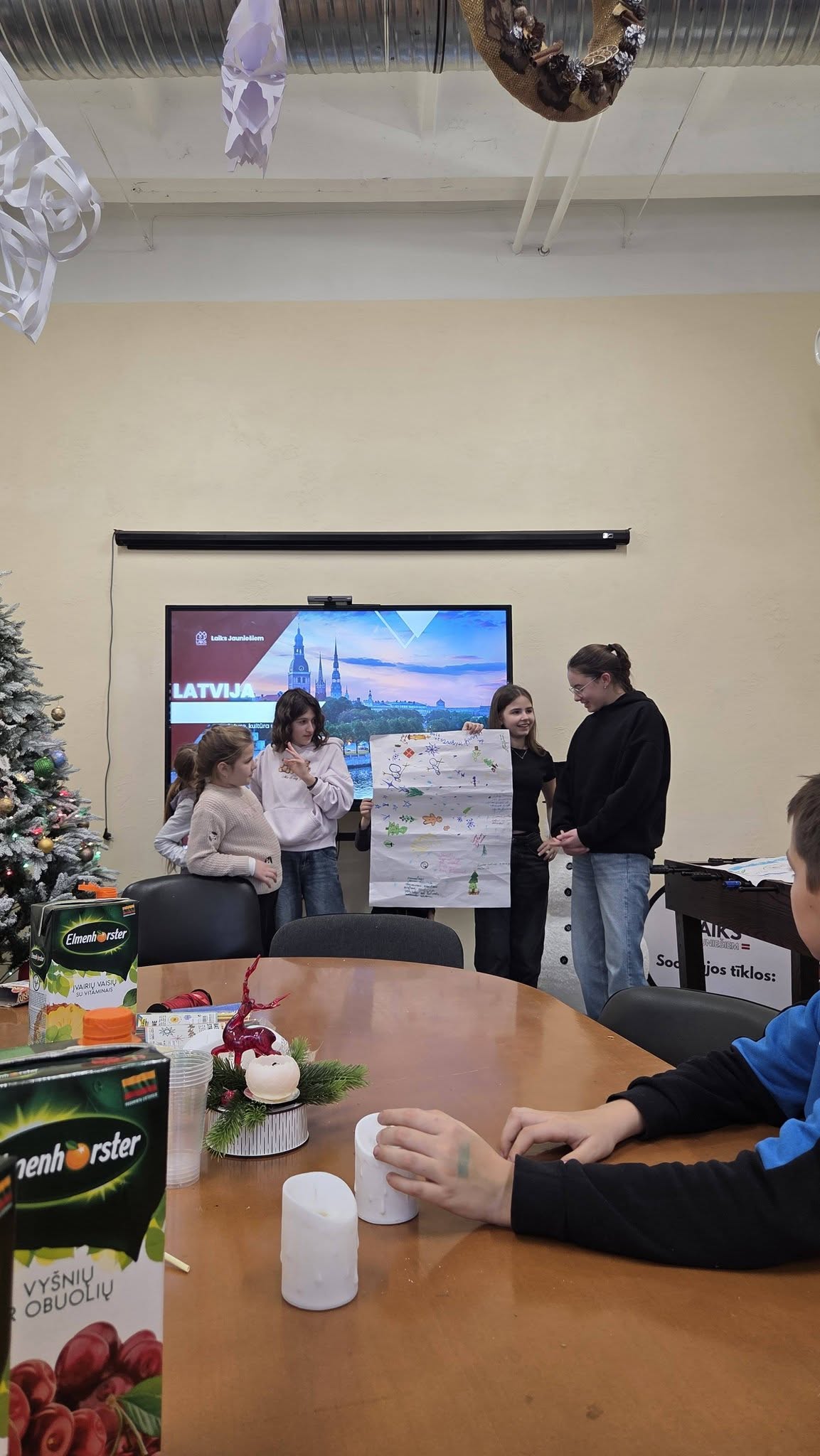 May be an image of table, television and text