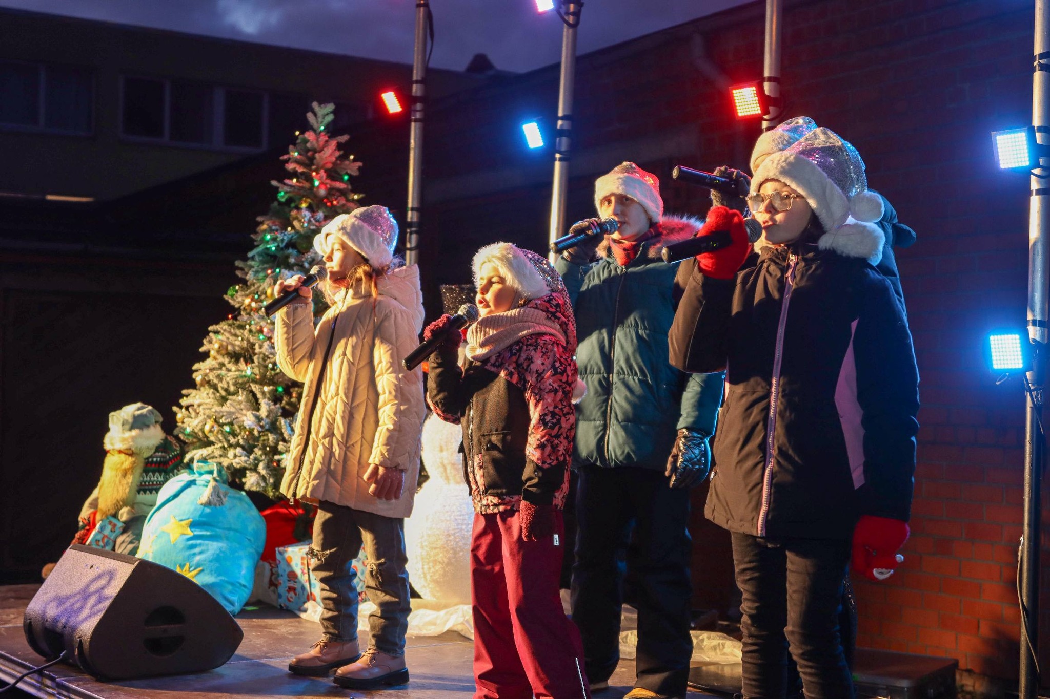 May be an image of one or more people, saxophone, christmas tree, street and text