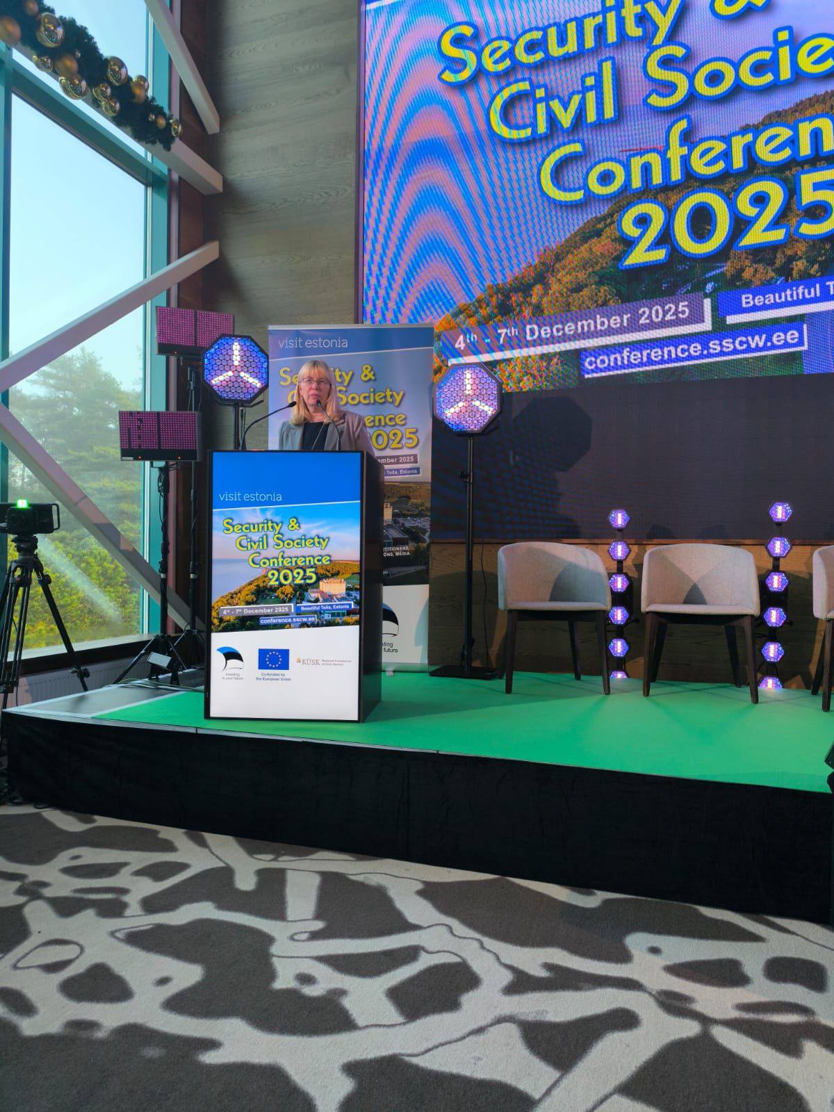May be an image of lighting, dais and text that says 'visitestonia eston visil Civil Security Socie Conferen 2025 Beautiful 7 December 2025 conference.sscw.ee conference. sscw.ee 4th ty Society ence 025 OeF2015 visit visitestonia Security & CivilSociety Civil Society Conference 2025 """"'